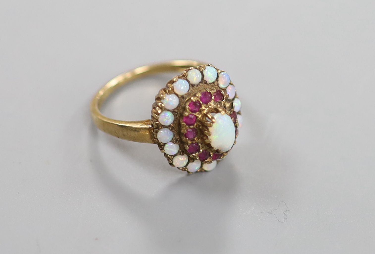 A 1960's 9ct gold, ruby and white opal set cluster ring (ruby missing)